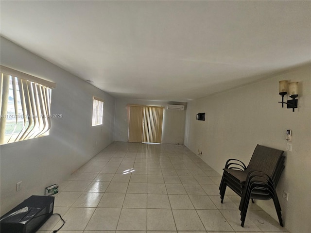 tiled spare room featuring a wall mounted air conditioner