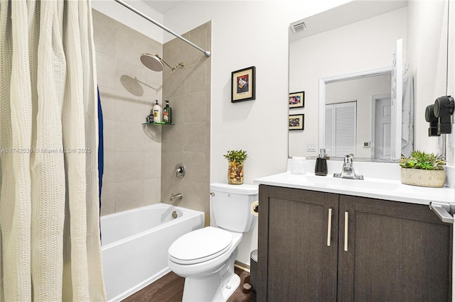 full bathroom with hardwood / wood-style flooring, vanity, shower / tub combo, and toilet