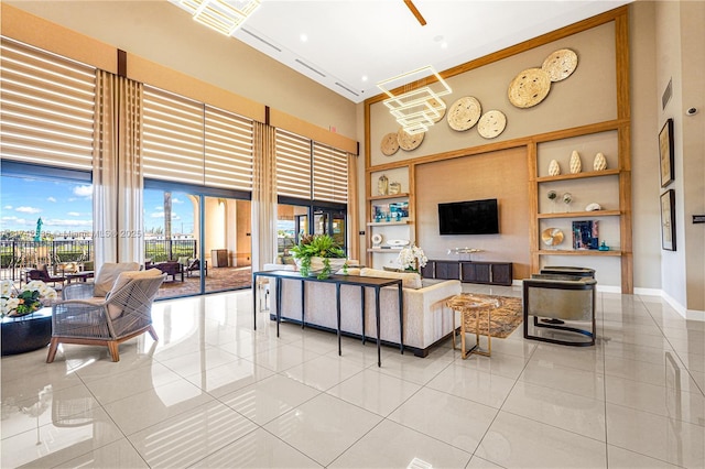 living room featuring a high ceiling and tile patterned flooring