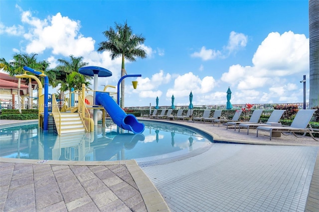 view of pool featuring a playground and a water slide