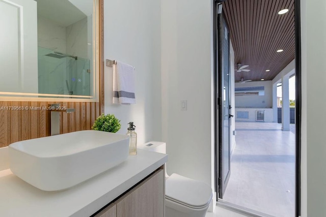 bathroom featuring vanity, toilet, an enclosed shower, and wooden ceiling