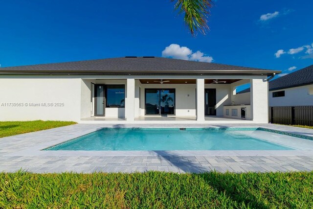 rear view of house featuring a fenced in pool, ceiling fan, and a patio area