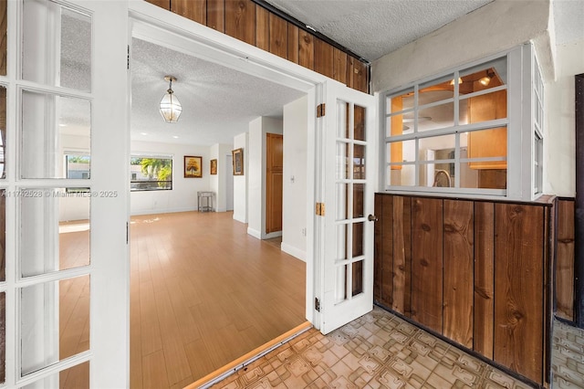 interior space featuring a textured ceiling and light hardwood / wood-style floors