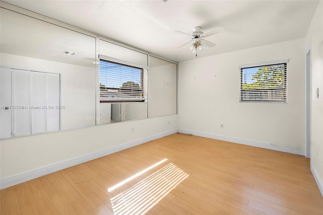 empty room with hardwood / wood-style flooring and ceiling fan