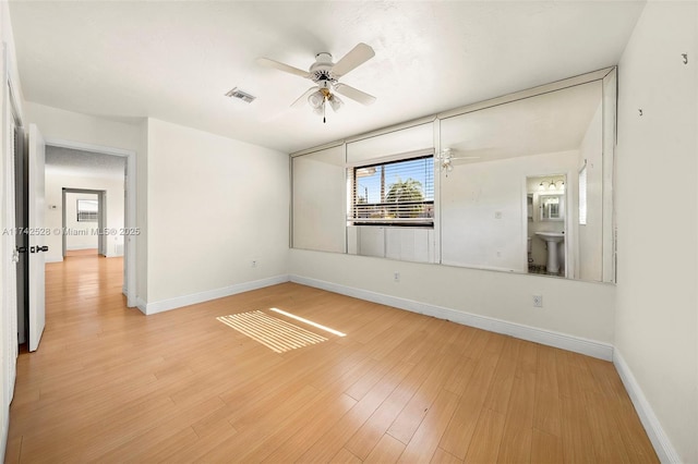 spare room with ceiling fan, sink, and light hardwood / wood-style floors