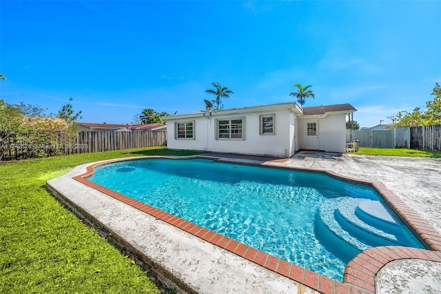 view of swimming pool with a lawn and a patio