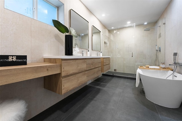 bathroom with plus walk in shower, tile walls, and vanity