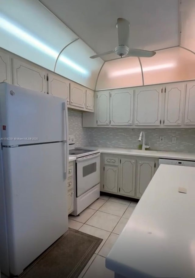 kitchen featuring light tile patterned floors, white appliances, sink, ceiling fan, and backsplash