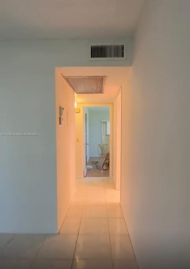 corridor featuring light tile patterned floors