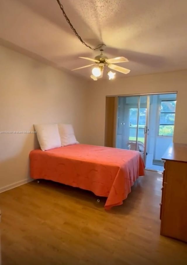 bedroom featuring ceiling fan, access to outside, and light wood-type flooring