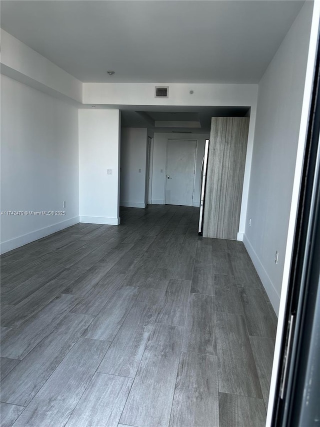 empty room featuring dark wood-type flooring