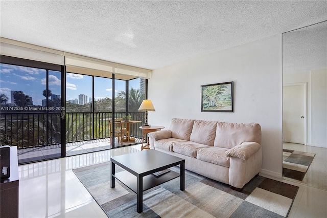 living room featuring floor to ceiling windows, tile patterned floors, and a textured ceiling