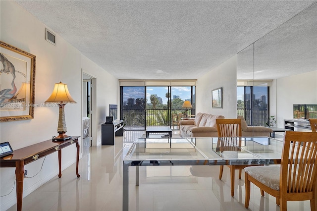 interior space featuring floor to ceiling windows and a textured ceiling