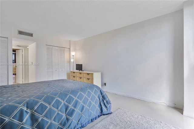 carpeted bedroom with a textured ceiling and a closet