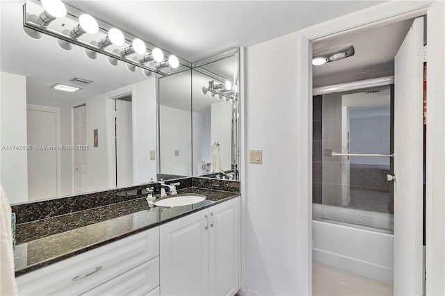 bathroom featuring vanity and bath / shower combo with glass door