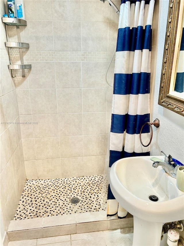 bathroom featuring sink and curtained shower