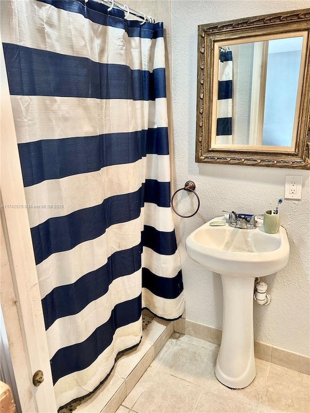 bathroom featuring tile patterned flooring and a shower with shower curtain