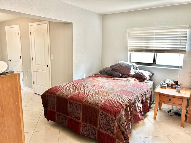 bedroom featuring light tile patterned floors