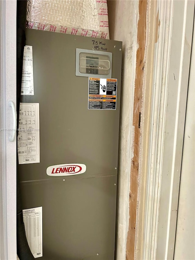 utility room featuring heating unit