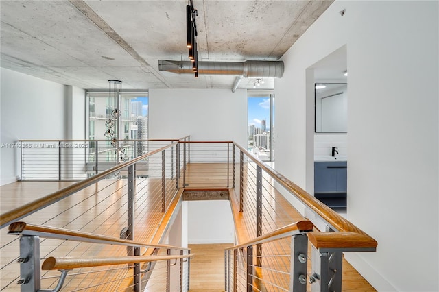 stairway with plenty of natural light and hardwood / wood-style floors