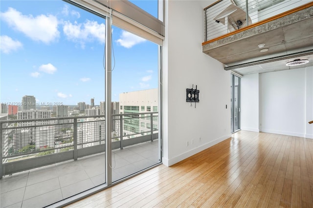690 SW 1st Ct Unit 3117, Miami, FL 33130 - empty room with a view of city, hardwood / wood-style floors, and baseboards