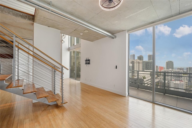 interior space featuring floor to ceiling windows and hardwood / wood-style floors