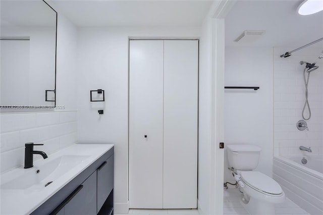 full bathroom with vanity, decorative backsplash, toilet, and tiled shower / bath