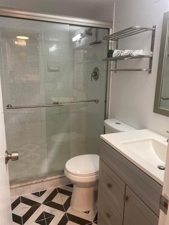 bathroom with vanity, toilet, and walk in shower