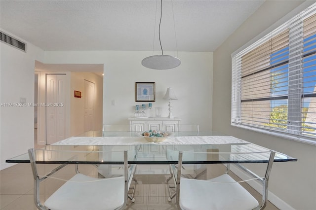 dining room with a textured ceiling