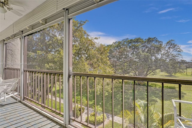 unfurnished sunroom with ceiling fan