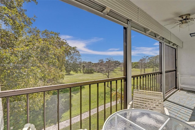 unfurnished sunroom with ceiling fan