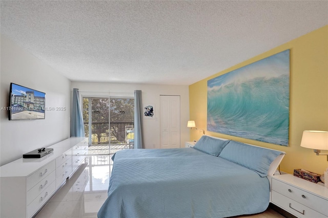 bedroom with light tile patterned floors and a textured ceiling