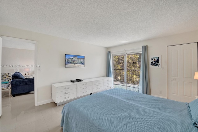 tiled bedroom featuring access to outside and a textured ceiling