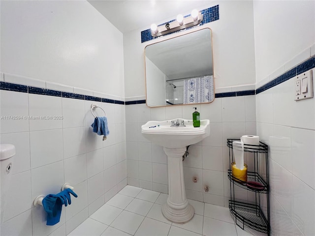 bathroom featuring tile patterned flooring and tile walls