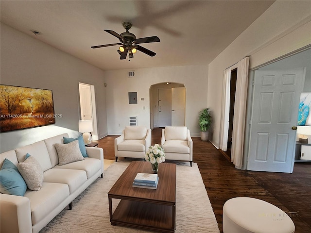 living room featuring ceiling fan and dark hardwood / wood-style floors