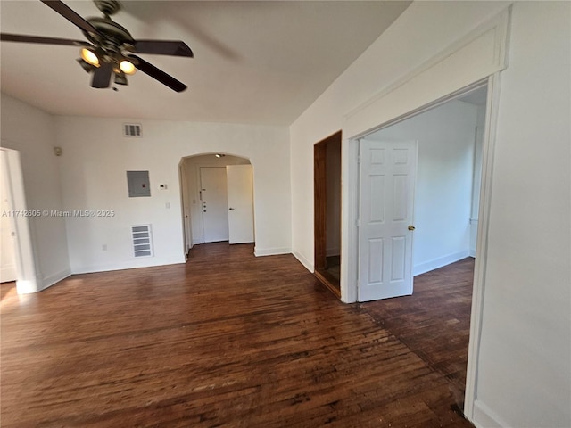 unfurnished room featuring ceiling fan, dark hardwood / wood-style flooring, and electric panel