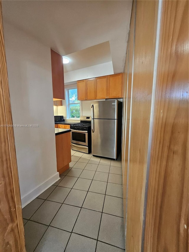 kitchen with appliances with stainless steel finishes and light tile patterned floors