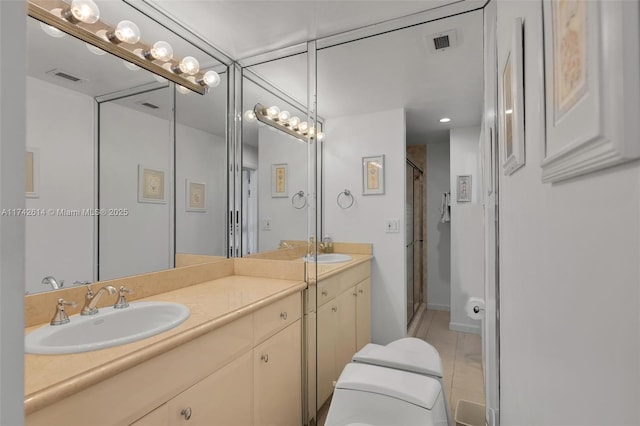 bathroom with vanity, tile patterned flooring, and a shower with shower door