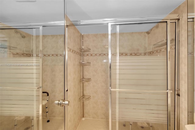 bathroom with a shower with door