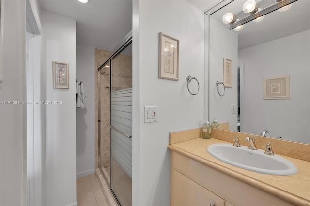 bathroom with an enclosed shower, vanity, and tile patterned floors