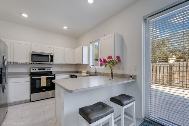 20849 NW 9th Path, Miami Gardens, FL 33169 - kitchen with white cabinetry, appliances with stainless steel finishes, sink, and kitchen peninsula