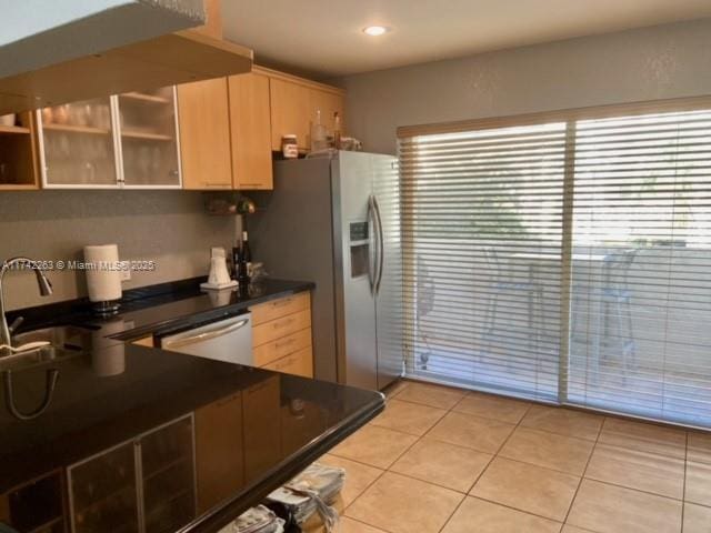 kitchen featuring appliances with stainless steel finishes, sink, light tile patterned floors, and light brown cabinetry