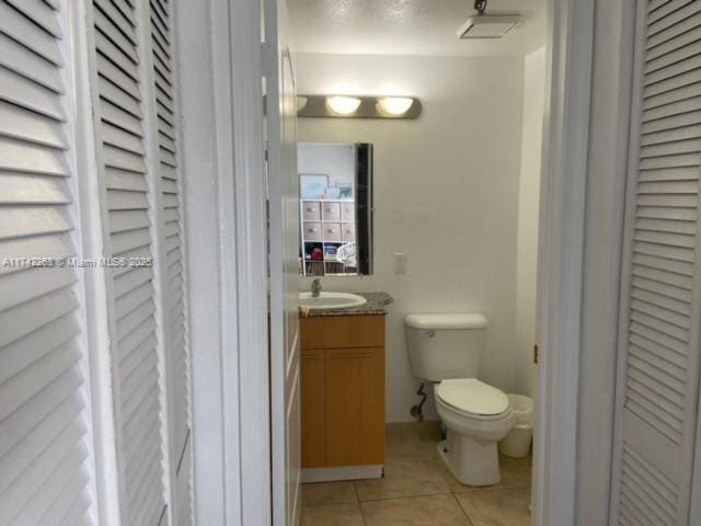 bathroom with tile patterned floors, toilet, and vanity