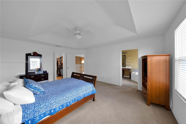 207 Berenger Walk, Royal Palm Beach, FL 33414 - bedroom with a walk in closet, light carpet, a tray ceiling, and a closet