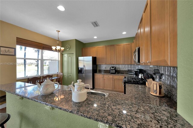 207 Berenger Walk, Royal Palm Beach, FL 33414 - kitchen with a peninsula, dark stone countertops, tasteful backsplash, visible vents, and appliances with stainless steel finishes