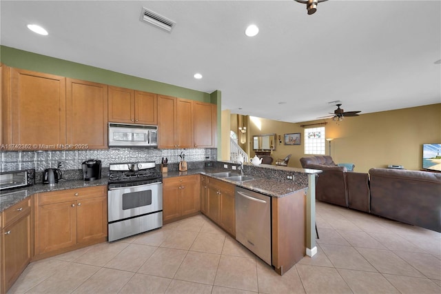 207 Berenger Walk, Royal Palm Beach, FL 33414 - kitchen featuring ceiling fan, open floor plan, stainless steel appliances, and visible vents
