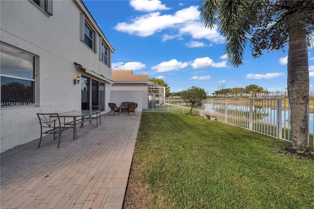 207 Berenger Walk, Royal Palm Beach, FL 33414 - view of yard featuring a fenced backyard, a water view, and a patio