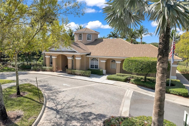 207 Berenger Walk, Royal Palm Beach, FL 33414 - mediterranean / spanish-style home with decorative driveway and stucco siding