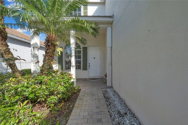 207 Berenger Walk, Royal Palm Beach, FL 33414 - view of exterior entry featuring stucco siding