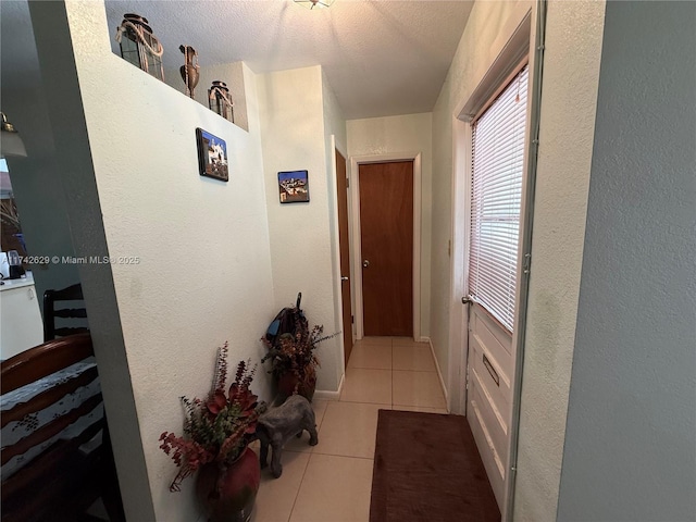 11277 SW 172nd St Unit I1742D, Miami, FL 33157 - corridor featuring tile patterned flooring and a textured wall